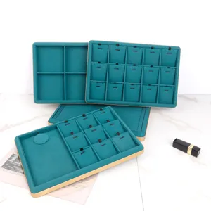 Detail of teal velvet jewelry display trays with luxury gold frames