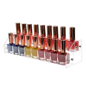 Detail of clear two-tier acrylic nail polish organizer rack with multiple colorful bottles