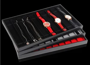 Detailed view of stackable 10-slot watch and jewelry display trays in black PVC material