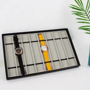 Detail view of 10-slot watch display tray with grey flocked lining and elastic bands