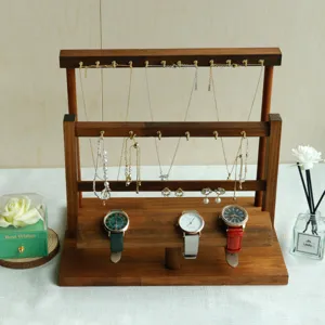 Walnut wood jewelry stand with hooks for necklaces and watches on a solid tiered base