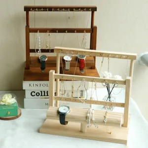 Tiered wooden jewelry storage rack displaying necklaces and watches in a lifestyle setting