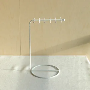 Minimalist white iron jewelry stand with multiple hooks for necklace storage