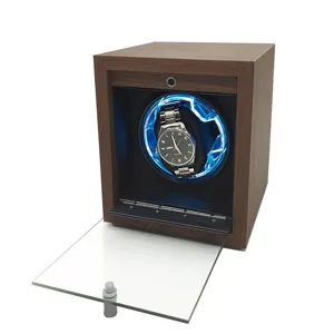 Close-up interior view of a premium black walnut wood watch winder with blue LED