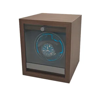 Detailed view of walnut wood automatic watch winder with blue LED light for mechanical watches