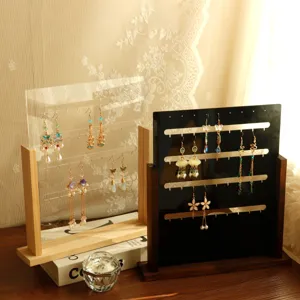 Detail view of vertical wood and acrylic earring display stands in light and dark finishes