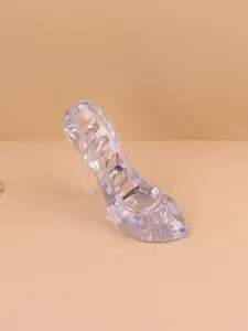 Detail of transparent crystal high-heel shoe display stand showcasing multiple rings.