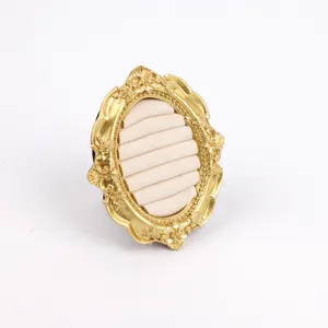 Detail view of a vintage gold resin jewelry display stand for ring organization