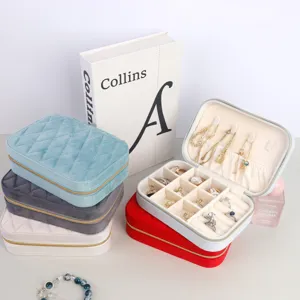 Detailed view of portable quilted velvet jewelry organizer boxes in multiple colors.