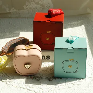 Macro view of apple jewelry boxes with Love heart emblem and matching ribbon gift boxes.