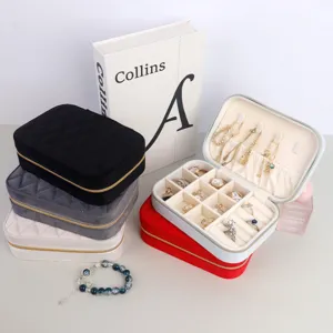 Portable quilted velvet jewelry box organizer with ring slots and necklace hooks detail