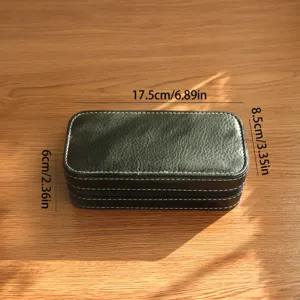 Close-up detail showing the dimensions of the vintage black leather watch storage box