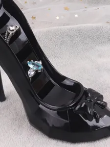 Close-up of a stylish black high heel jewelry display stand holding elegant rings