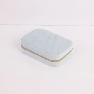 Detailed view of light blue quilted velvet travel jewelry box with golden zipper