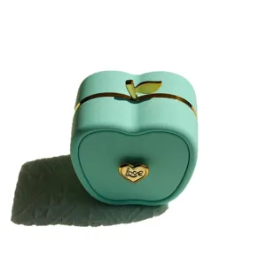 Mint green apple-shaped jewelry gift box with golden heart detail