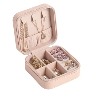Portable light pink travel jewelry storage box with compartments for rings and necklaces