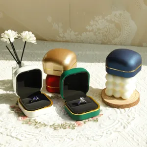 Detailed view of luxury colorful jewelry boxes with gold trim in a elegant setup