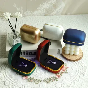 Multiple elegant velvet jewelry boxes with LED light in green, red, gold and blue colors
