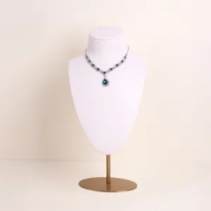 Detail view of a premium off-white microfiber necklace display bust with gold metal stand