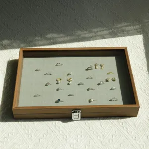 Detailed view of large capacity walnut grain jewelry storage box with glass lid and velvet slots