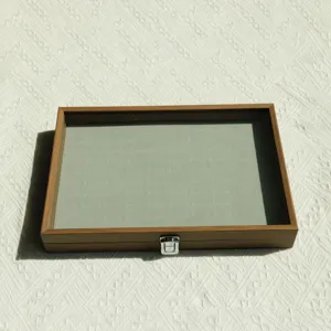 Walnut wood jewelry storage box with velvet interior and clear lid for ring display