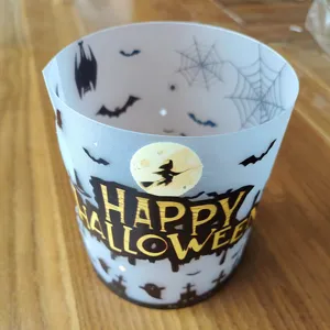 Halloween candle lampshade detail view, frosted translucent cylinder wrap with spooky bat and witch design.