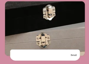 Macro detail of the silver metal latches on elegant black and grey velvet jewelry boxes