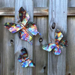Colorful metal butterfly wall art hanging decor detail showcasing vibrant painted finish.