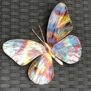 Colorful metal butterfly ornament detail shot, perfect for home wall decoration and crafts.