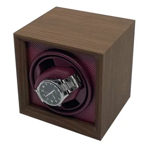 Close-up detail of dark walnut wood automatic watch winder with maroon interior lining