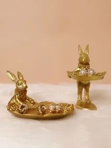 Vintage gold rabbit jewelry display trays showing earrings on white faux fur background