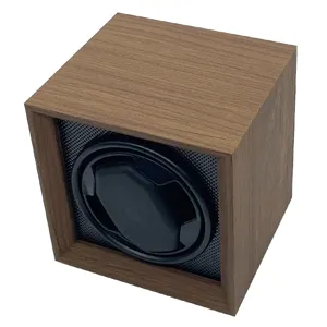 Detailed view of a vintage walnut wood automatic watch winder box with black interior