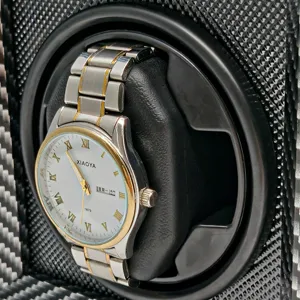 Close-up of automatic mechanical watch winder with carbon fiber pattern interior