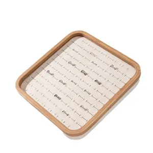 Elegant bamboo ring display tray with multiple velvet slots for jewelry storage