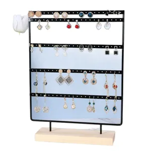 Large black iron earring display stand with wooden base and five hanging rows.