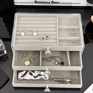 Close-up of three-layer velvet jewelry organizer with crystal knobs and clear drawers