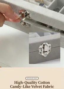 Boîte à bijoux en velours gris avec couvercle en verre et fermoir pour bagues et boucles.