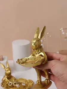 Close-up of vintage golden rabbit jewelry display tray for photography props