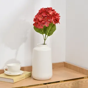 Artificial red hydrangea flower with white ceramic vase for wedding home decor detail.