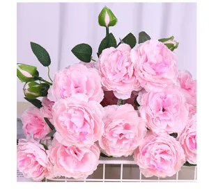 Detailed close-up of artificial pink ranunculus peony bouquet flowers for home decor setup.