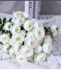 Detailed close-up of white artificial peony flowers bouquet on grid fabric for home decor.