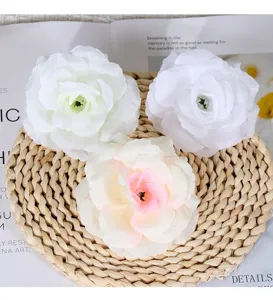 Close-up detail of artificial silk rose flower heads in white and pink for floral decor.
