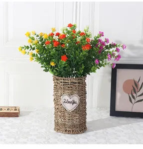 Artificial eucalyptus rose flower bouquet in woven vase for home decor interior detail.