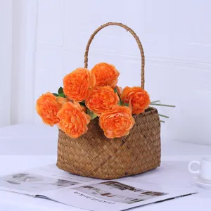 Artificial peony rose flower arrangement in woven basket for home decor living room table display detail