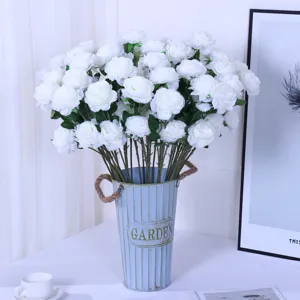 Artificial white ranunculus silk flowers bouquet in blue metal vase home decor detail