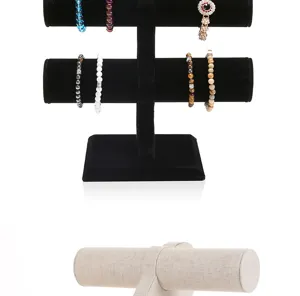 Detailed view of black velvet and beige linen T-bar jewelry display stands for bracelets