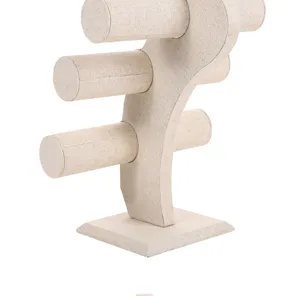 Close-up detail of a 3-tier linen jewelry display stand for bracelets and watches
