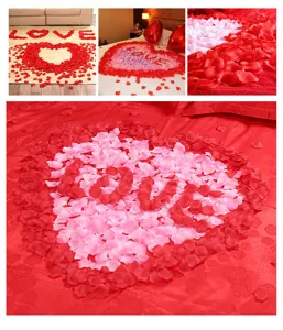 Artificial rose petals detail showing red and pink fabric petals arranged for wedding room decor.