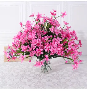 Artificial pink orchid flower bouquet with glass vase for home decoration and room display.