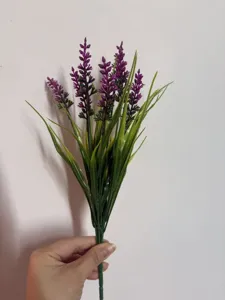 Close-up detail of artificial purple lavender bouquet with green leaves for home decoration.